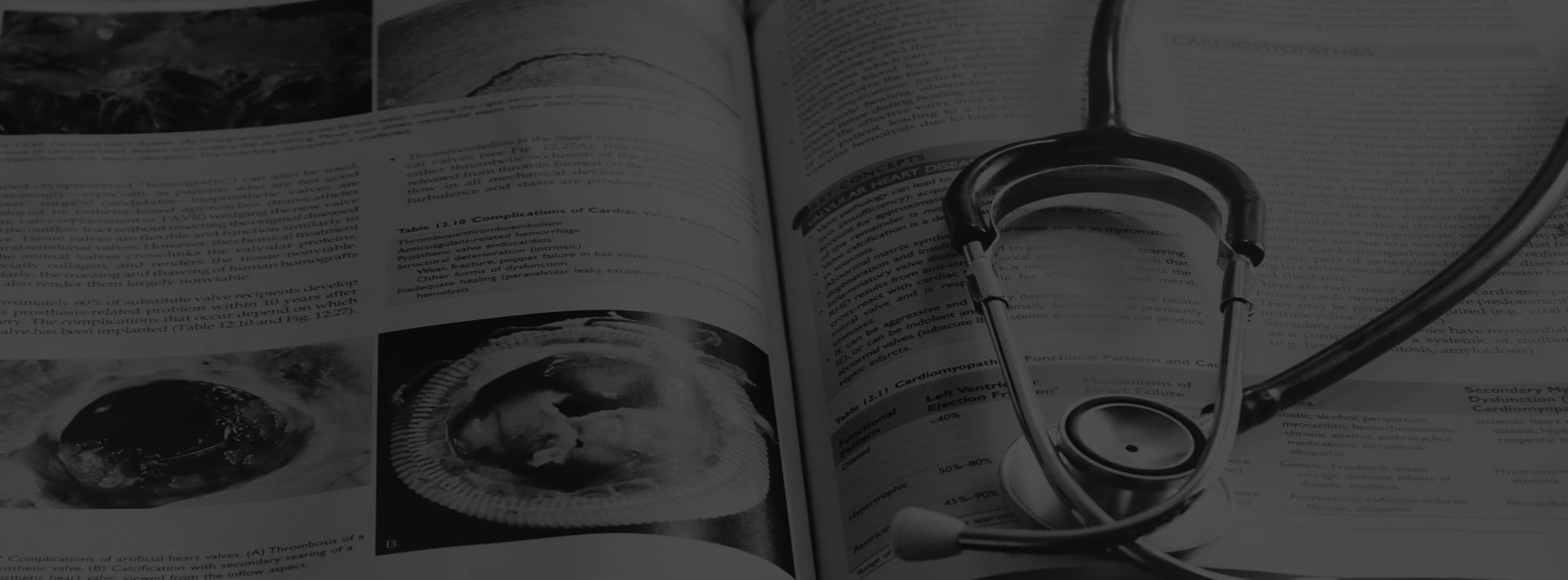A black and white image of a stethoscope on an open book.
